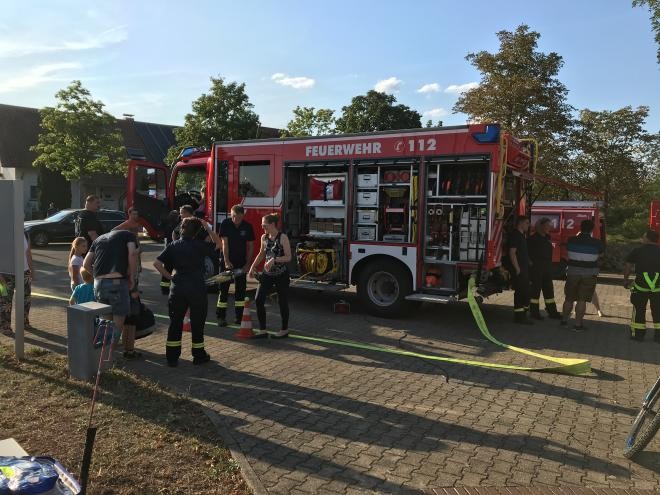 Feuerwehrauto und Feuerwehrleute im Einsatz